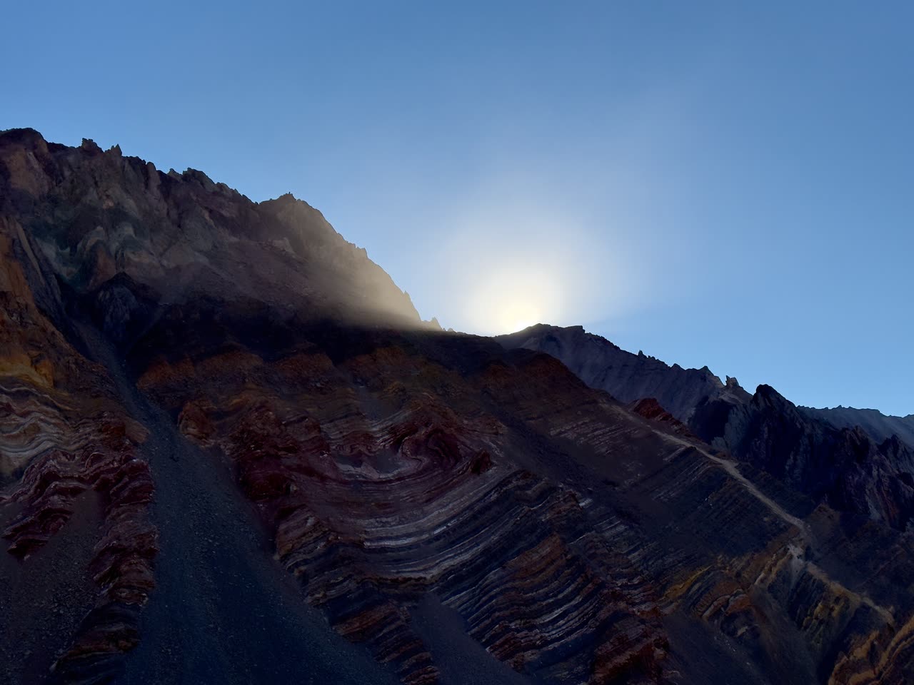 Dramatic colorful sedimentary rock layers on a cliff face