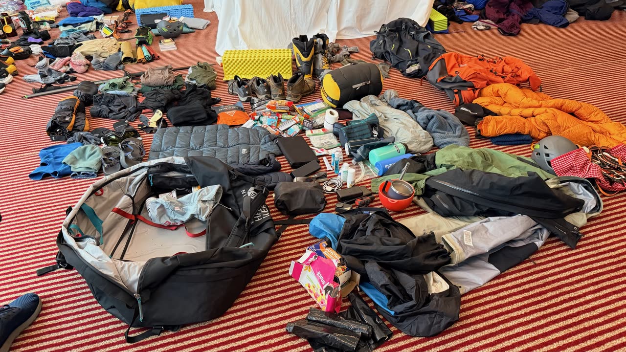 Mountaineering gear spread across a hotel floor