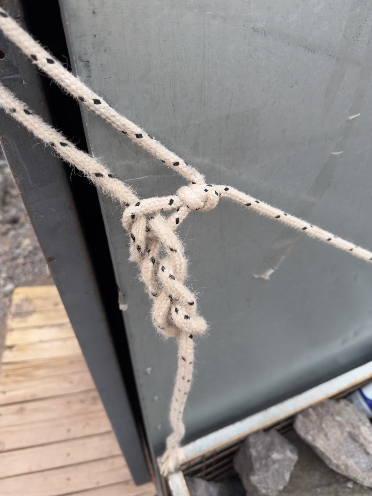High-camp bathroom shelter with a flag in strong wind