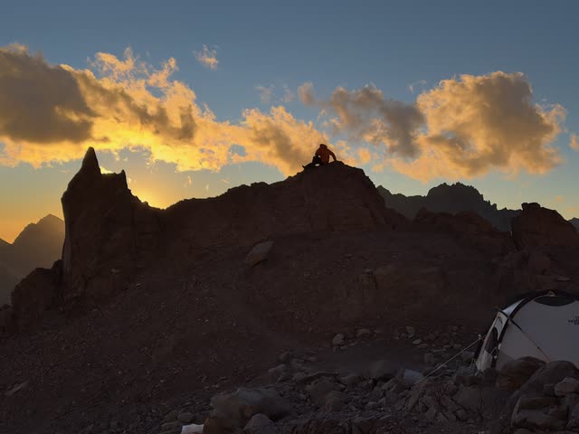 Rock formations silhouetted against golden sky