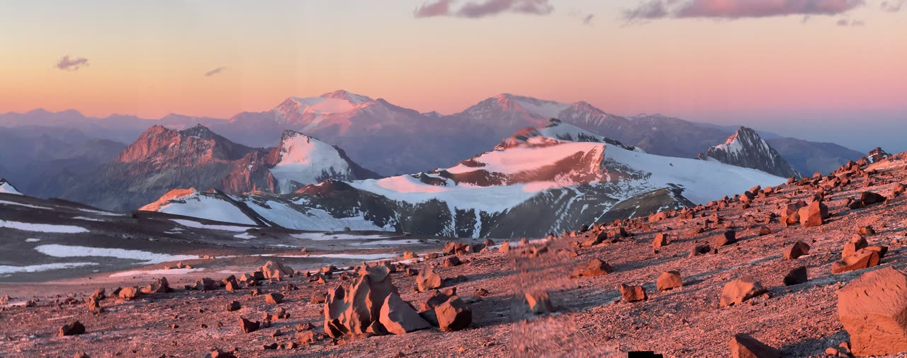 Snowy peak glowing orange in evening light