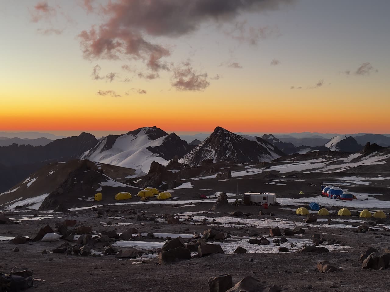 Deep red and orange sunset over mountain peak