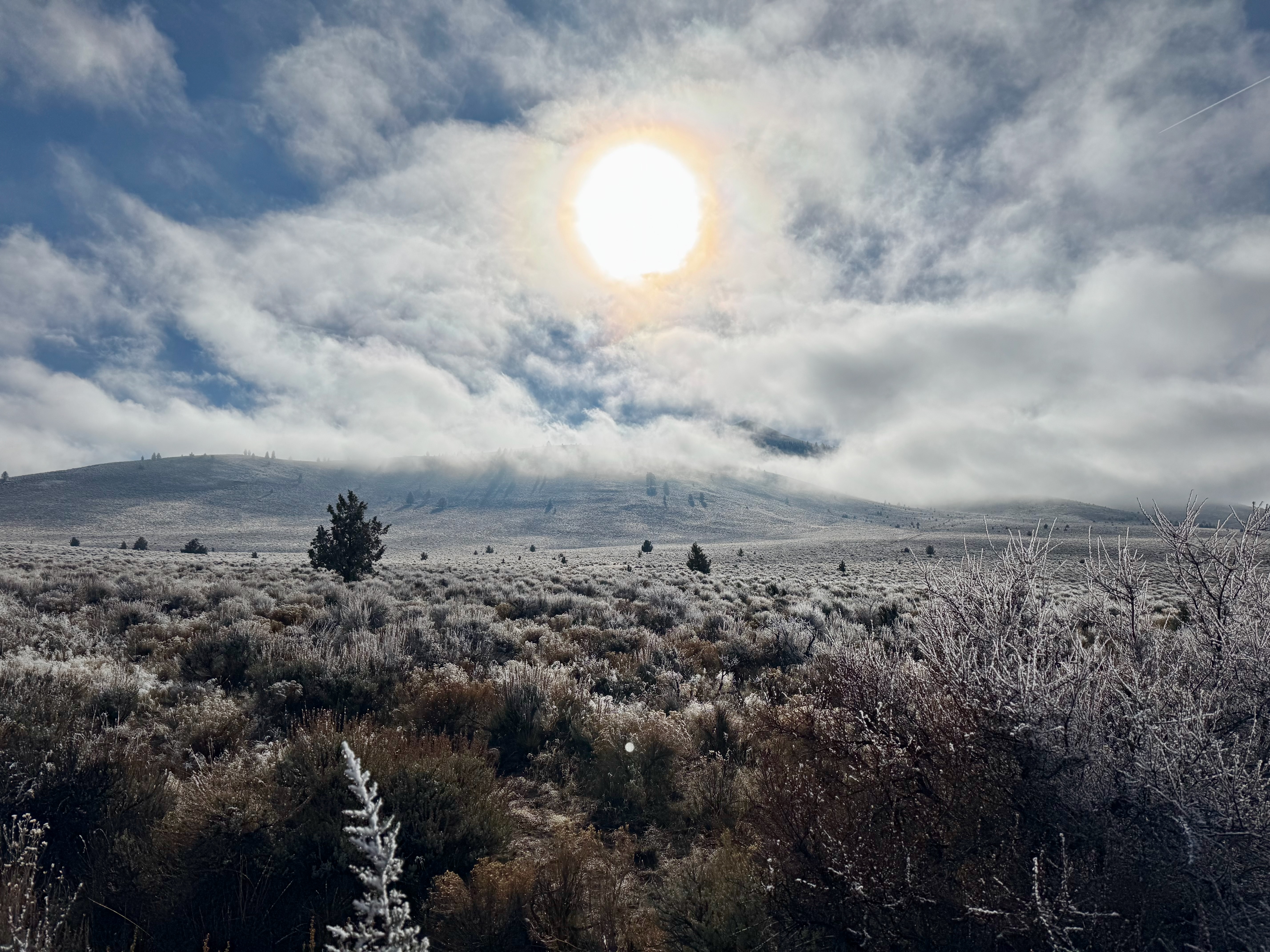 Sun breaking through clouds over Pine Mountain