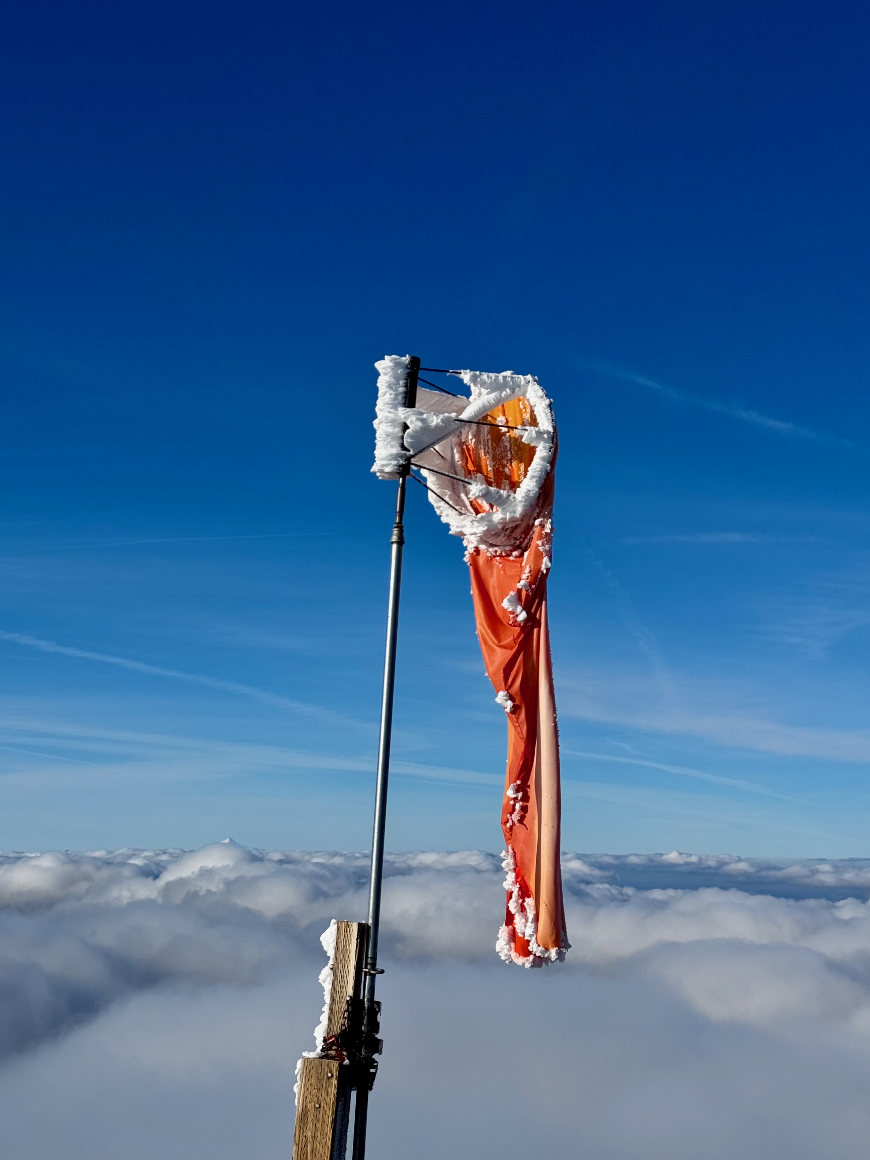 Frozen paragliding windsock above cloud deck