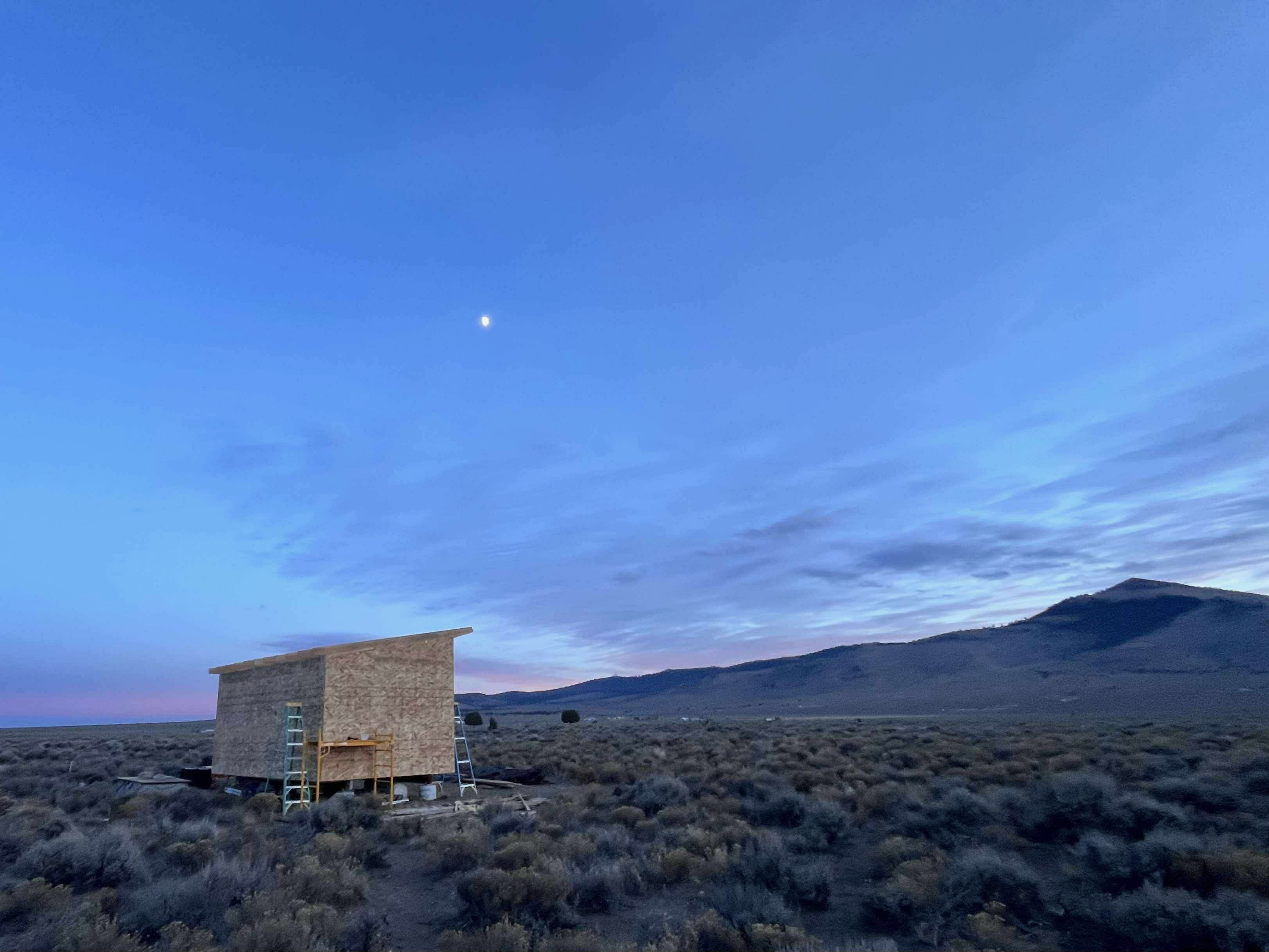 Sheathed Millican house at dusk with big sky
